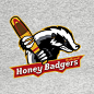 This may contain: the honey badger's t - shirt is shown with a baseball bat