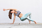 Fit sporty active girl in fashion sportswear doing yoga fitness exercise in front of gray wall,...
