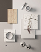 This may contain: an assortment of items displayed on a table with white and grey colors, including vases