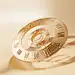 liujunjun__An_empty_golden_spinner_with_roman_numerals_on_a_bei_c75fb2e6-de0f-4b22-82f9-899ba7e35026