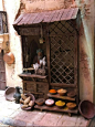 This may contain: an old wooden cabinet with pots and pans on the floor in front of it