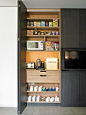 Example of a trendy porcelain floor kitchen pantry design in London with flat-panel cabinets and black cabinets