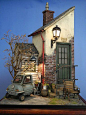 This may contain: an old car is parked in front of a house with a lamp on the roof