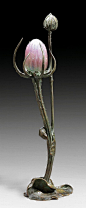 BOUVAL, MAURICE. (1863 - 1920). 'CHARDON' TABLE LAMP, circa 1900. Bronze with green patina. Pink glass paste shade. Signed M. Bouval. H 54 cm. BOUVAL, MAURICE (1863 - 1920) LAMPE DE TABLE 'Chardon', vers 1900 Bronze à patine verte avec abat-jour en pâte-d