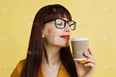 咖啡爱好者，休息时间，早上好。近距离拍摄的漂亮的年轻女商人在眼镜和红色的口红，享受咖啡的味道。孤立在
