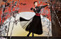 This may contain: a woman in a black dress and red belt is dancing on stage with bamboo trees