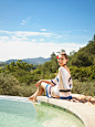 Woman dipping feet in water sitting on edge of infinity pool at a luxury resort overlooking Napa Val by Gable Denims on 500px