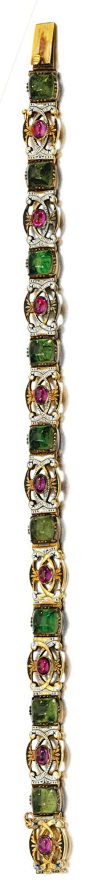 GOLD AND ENAMEL BRACELET, CARLO GIULIANO, 1874-1895 Of pierced openwork scroll gold design, decorated with monochrome enamel, accented with cabochon rubies and green paste, length approximately 175mm, maker's mark, fitted case stamped C. Giuliano.@北坤人素材