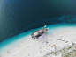 Drone aerial view of the boat being repaired on the sand beach in Pointe Figuier, Sud Department, Haiti