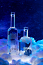 Liquor product photography and videography for Dark Sky Distillery. Glass vodka and gin alcohol bottles featured in dark, powerful campaign with neon coloured lights, dramatically splashing liquids, atmospheric haze, illuminated clouds, and a galaxy backg