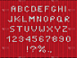 圣诞季节字体平面矢量插图. 针织物风格的字母和数字集。 带有数字和符号的冬季字母。 红色针织物质地的