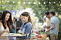 Photograph Women arranging tray of snacks for backyard party by Gable Denims on 500px