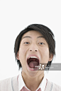 Young man with mouth wide open, portrait, close-up, studio shot_创意图片