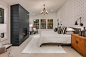 Inspiration for a large country master carpeted and gray floor bedroom remodel in Seattle with white walls, a standard fireplace and a wood fireplace surround