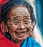 'A Face and Smile To Remember'   I was walking down a street in Kathmandu, and I saw this lady just laughing like there was no tomorrow while sitting on a wood bench...I have no idea what she was laughing about, but she loved to have her photo taken...whi
