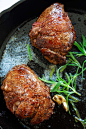 Filet mignon recipe with butter, garlic and rosemary, cooked on a skillet on stove top.