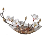 Faux white magnolias in clear bowl.    Product: Faux floral arrangement   Construction Material: Fabric, acrylic an...: