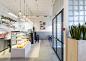 Baranova Pokorsky creates plant-filled cafe in St Petersburg : Baranova Pokorsky has transformed a Soviet-era furniture store into a vegetarian coffee shop, pairing simple materials with plant-lined shelves