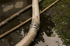 大雨后城市公园被淹。用于抽水的消防软管。