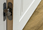 New modern metal door hinges on white wooden doors