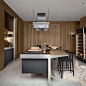 This may contain: a modern kitchen with an island and wine rack