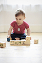 Baby boy playing with toy blocks arranged to read "E=mc2" by photoalto on 500px