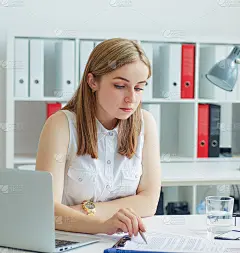该职业介绍所的年轻女员工帮助男性求职者填写表格。