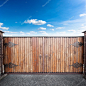 Closed wooden gates over sky background