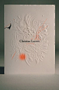 其中可能包括：a white card with an orange marker on it that says christian larroie in the center