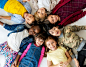 A group of primary schoolers lying on the ground and smiling Free Photo