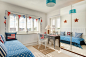 Example of a small beach style carpeted kids' room design in Devon with white walls