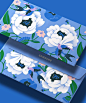 This may contain: two samsung laptops sitting next to each other on a blue background with flowers and leaves