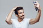 Young man applying hair spray to his hair by Milenko Đilas on 500px