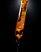 obooooooo_a_test_tube_with_amber_liquid_dripping_from_the_tip_o_e3b23d58-c75f-4974-a6d1-9ce7c72f665f