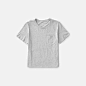 The Cotton Box-Cut Pocket Tee : A gamine box cut tee made from the softest lightweight cotton we could find. The roomy cut is cropped to sit right above the hip. It features a boyish crew neck and pocket detail, and the fabric is a combed cotton that gets