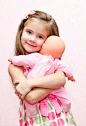 cute-little-girl-holding-embracing-her-doll-isolated-47197937
