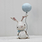 LILY : LILY (has a sweet and very giving nature)    This 7 (including the balloon) white bunny Is hand sculpted from paper clay. Painted in acrylics,