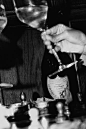 This may contain: two people are pouring wine into glasses