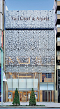 The Van Cleef & Arpels logo on the wall of the conference room at the Tokyo flagship by Jouin Manku also inspired the shapes of an exterior screen. Photography by Take...