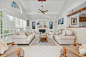 Photo of a large open plan living room in Sunshine Coast with a home bar, white walls, a standard fireplace, a tiled fireplace surround, beige floors and no tv.