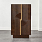 Shop Detour Brown Wine Cabinet. Linear rib detailing takes a detour in the center of this mindi wood wine cabinet by Ceci Thompson. Two vertical gold leaf handles meet in the middle with rounded edges.