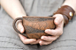 This beautiful mug is decorated with intricate, hand-carved designs.
