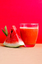 Watermelon Shake Filled Glass Cup Beside Sliced Watermelon Fruit on Brown Surface