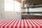 Empty table with tablecloth and blurred kitchen background