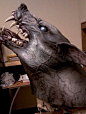 This may contain: a sculpture of a dragon with its mouth open and teeth wide open, sitting on a table