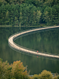 floating cycling bridge curves through pond in belgium adapting to water levels