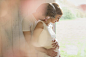 Affectionate pregnant couple hugging at window by Caia Images on 500px