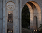 The luminaires are mounted in pairs at the base of each arch.