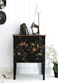 small black, floral, painted with birds, foyer console table/chest, white walls, eclectic, antique lamp and books.
