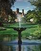 View of water fountain and mansion during the annual Tulip Festival at Pashley Manor Gardens, Pashley Manor, East Sussex, England.
